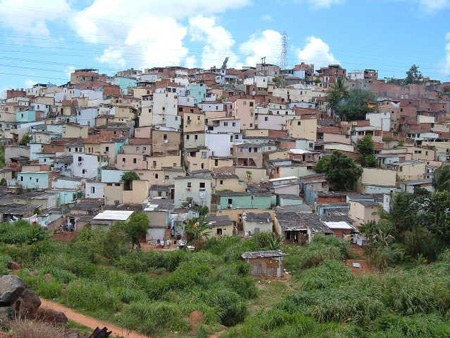 Par la visita del Papa, on fià de ritoco a la favela, ma in realtà se trata de “ammassi di materiali recuperati in discarica, pezzi di legno, di cartone, di lamiera, di plastica... assemblati con un certo ordine a formare dei cubicoli dove le persone possono almeno tentare di ripararsi dal sole torrido dell'estate e dalle torrenziali piogge tropicali dell'inverno.” (foto e parte de na létera de Ilaria Menini dal Brasile) 